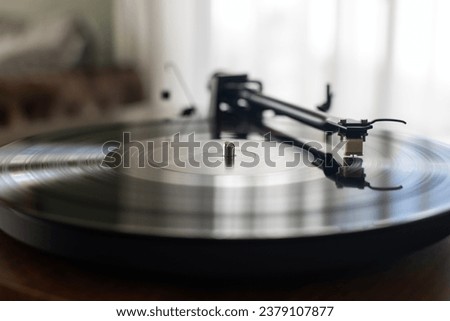 Vinyl record with music on retro dj turntable player. Turntables needle on analog disc with hip hop music. Listen to the musical tracks in hi fi quality with vintage turn table device