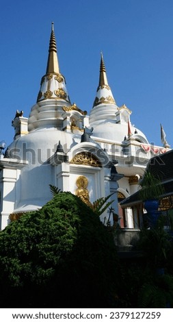 The white Buddhist temple looks facade