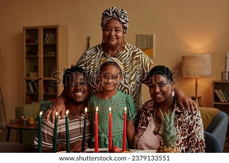 Happy three generation Black family celebrating Kwanzaa at home