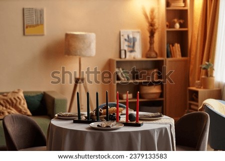Red, Black and green candles in the center of dinner table served for family Kwanzaa celebration