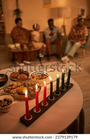 Red, green and Black burning candles set on table decorated for Kwanzaa celebration