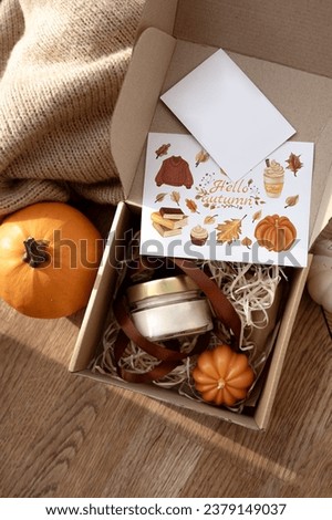 autumn candle box. Autumn cozy composition. Pumpkins, candles in a box. Fall, fall, Thanksgiving decor. Flat layout. Beeswax candle in the shape of a pumpkin. Candle making business
