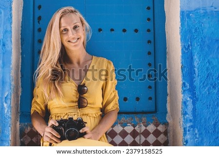 Smiling photographer near old building