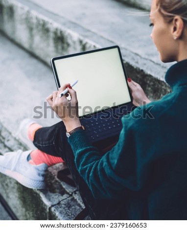 female digital nomad working remotely on blank touch pad connected to 4g for networking 