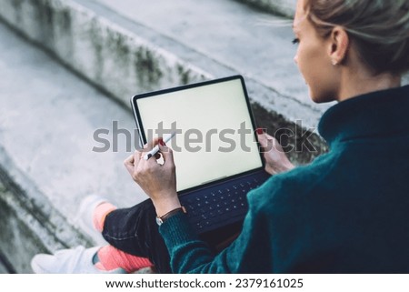 female digital nomad working remotely on blank touch pad connected to 4g for networking