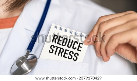 Reduce Stress text on white card in hand doctor taking it out of his pocket