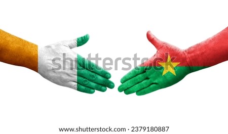 Handshake between Burkina Faso and Ivory Coast flags painted on hands, isolated transparent image.