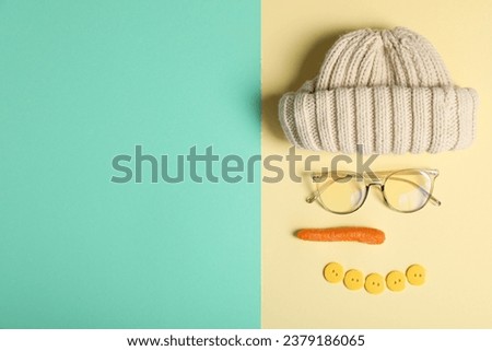 The face of a snowman with a carrot, glasses and buttons