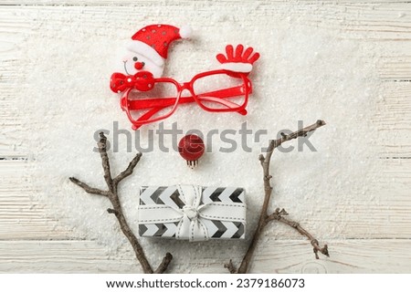Red glasses with a gift and a Christmas ball