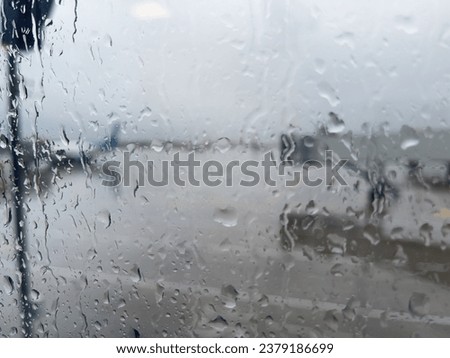 Raindrops on the window pane, rainy weather. Raindrops on the window pane at the airport window.