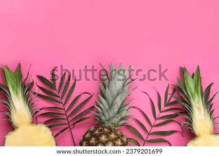 Whole and cut ripe pineapples on pink background, flat lay. Space for text