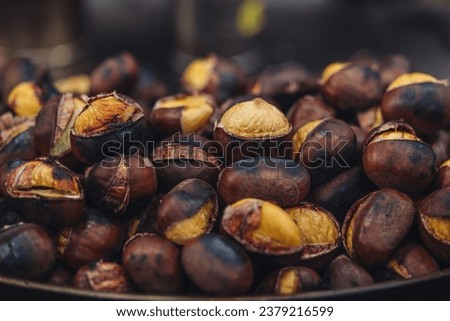 Roasted chestnuts on sale in Milano Royalty-Free Stock Photo #2379216599