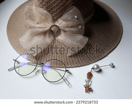 hat with hatband and glasses for vacation equipment during holiday Royalty-Free Stock Photo #2379218733