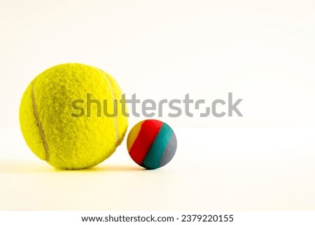 Rubber ball of various colors on a keyboard on dark background