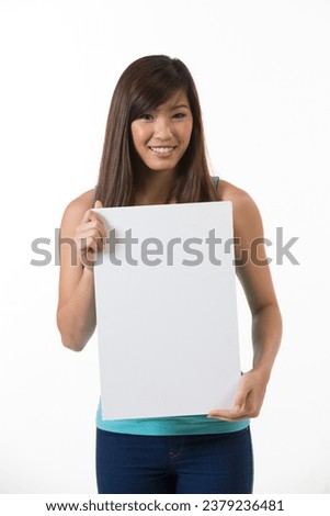 Chinese woman holding up a banner against a white background. Cardboard placard is blank ready for your message.
