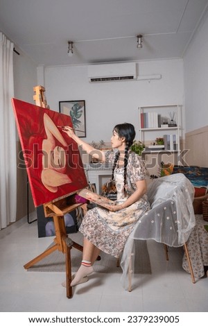 Artist, illustrator, Asian woman, dark brown hair in braids Sit and paint oilacrylic paintings in the gallery. Use your creativity It's a whole career. Hobbies for enjoyment
