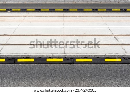 Closeup on road delineator for safety in city. Separator lines for cars and transportation. Roadway marking, barrier blocks on freeway. Warning elements on carriageway