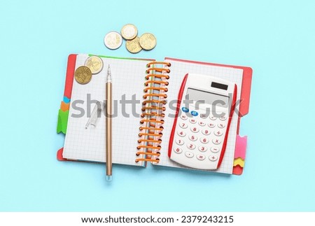 Calculator, money and notepad on blue background