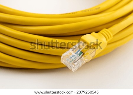 yellow network cable, isolated on white background. Closeup LAN cables with connector. Lan cable for internet network connection, gray lan cable on a white background. Ethernet network cable roll. Royalty-Free Stock Photo #2379250545