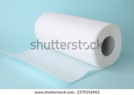One roll of paper towels on light blue background, closeup Royalty-Free Stock Photo #2379256963