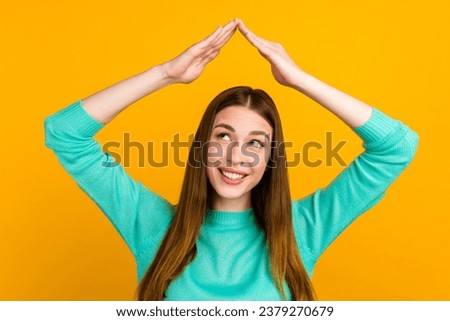 Photo portrait of woman making roof over head with hands look isolated on bright colored background.