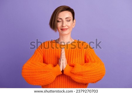 Photo of young woman dressed shirt closed eyes practicing yoga isolated purple background.