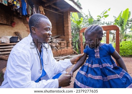 Friendly young Pediatrician visiting a sick baby girl in the village.