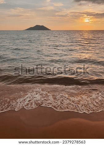 sunset picture with sea island and beach in Thailand, the wave hitting the sand make a very relexing voice.