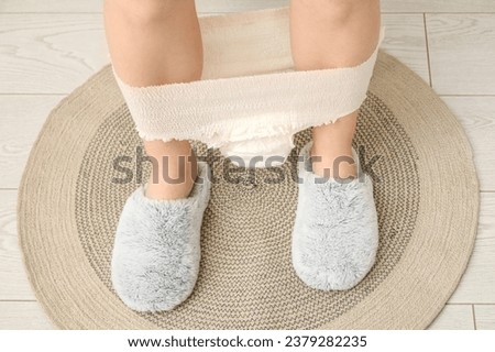 Woman with period panties sitting on toilet bowl, closeup