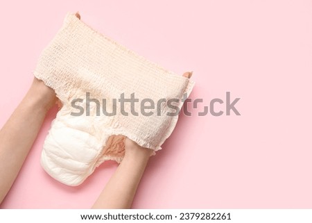 Woman with period panties on pink background