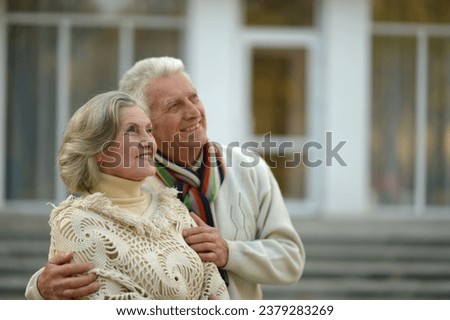 Elderly cute couple dance in the park in autumn. 