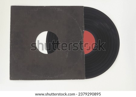 Aged black paper cover and vinyl record isolated on white background