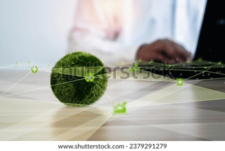 A globe with network lines and icons and a businessman sitting at a computer. Environmental concept, business or green investment For advertisements or web banners etc. Leave a space to enter text.