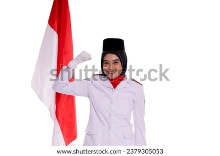 Portrait of A young Indonesian woman wearing a special uniform for independence day smiling to the camera while rising the right hand. 