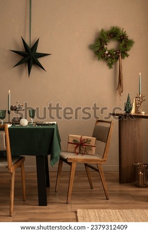 Christmas dining room interior with table, green tablecloth, wooden console, christmas wreath, chair, gifts, candle with candlestick, grown wall and elegant accessories. Home decor. Template.