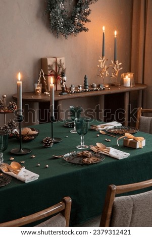 Christmas composition of dining room interior with family table, christmas tree, furniture, decoration, stars, gifts, accessories, deer, candlestick, candle and hanging wreath. Home decor. Template.