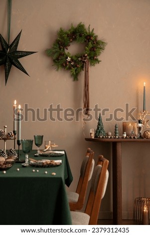 Interior design of Christmas dinning room interior with table, christmas wearth, candle, brown wall, star on wall, candle with candle stick. christmas accessories. Home decor. Template.