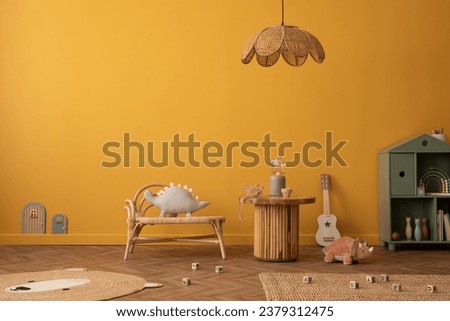 Creative composition of warm and cozy kid room interior with copy space, yellow wall, wooden coffee table, bear carpet, plush toys, children's kitchen and personal accessories. Home decor. Template.