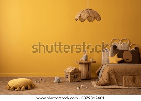 Aesthetic composition of kid room interior with yellow wall, guitar, rattan bed, toys, plush monkey, guitar, rattan lamp, toys, colorful garland and personal accessories. Home decor. Template. 