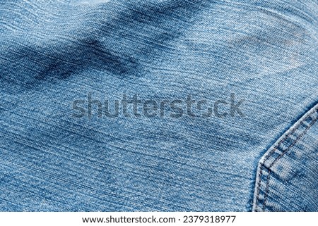 Jeans Fabric Pattern Background: Jeans Background Image Creating a background picture with a fabric pattern for jeans can add a unique and stylish touch to your design. Here's how you can describe  Royalty-Free Stock Photo #2379318977