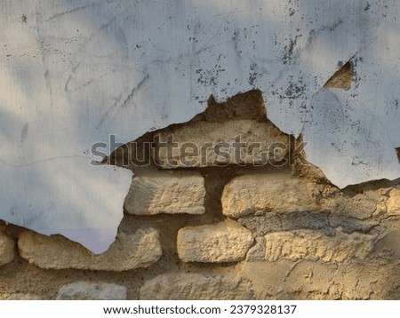 a wall that was destroyed to reveal a pile of bricks