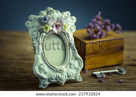 Still life with vintage classic photo frame and key