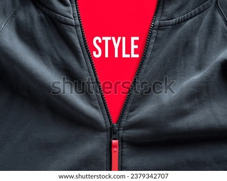 Opened zipper of a hoodie showing a red tag with the word style. Fashion and casual sportwear clothing. Royalty-Free Stock Photo #2379342707