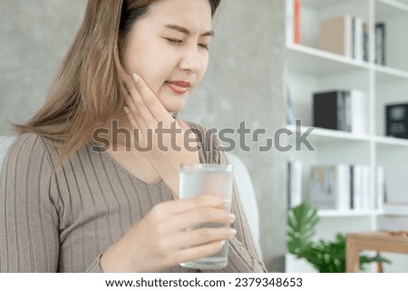 Asian woman feel sensitive teeth after drinking cold, female suffer tooth, decay problems, dental care, tooth extraction, decay problem, bad breath, Gingival Recession, Oral Hygiene instruction Royalty-Free Stock Photo #2379348653