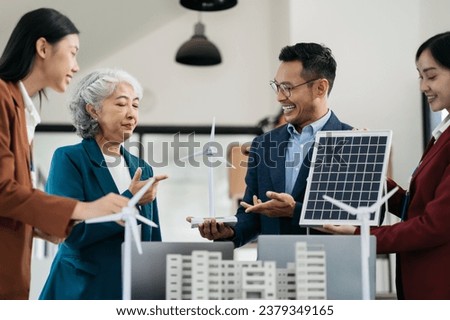 Businessman team brainstorming using tablet, laptop computer for working technology and business,  Renewable energy-based green businesses and global warming. green energy and solar panel concept.