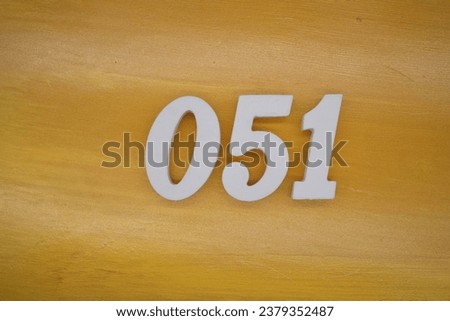 The golden yellow painted wood panel for the background, number 051, is made from white painted wood.
