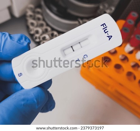 Influenza A virus positive test result by using rapid test device Royalty-Free Stock Photo #2379373197