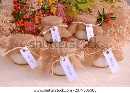 Fall wedding favors decoration candles guest gifts burlap fabric and jute ribbon decor autumn berry and flowers background, small gifts, diy, handmade ideas, brown, white, natural, orange colors