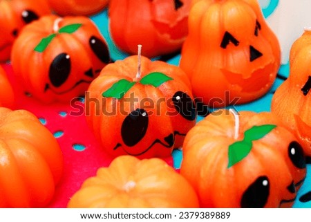 candles in the shape of traditional Mexican pumpkins in which they are representing the day of the dead or Halloween, they have friendly and happy faces