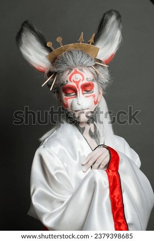 Attractive young woman in Halloween or carnival costume on black background